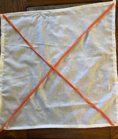 Image showing how to find center of bandana using two strings