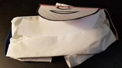 Image showing how to tuck the tabs into the bottom of the bandana